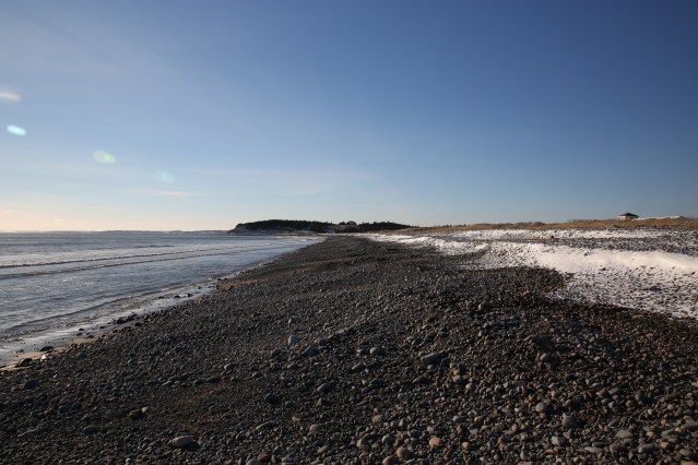 A rocky beach, just outside of Halifax, Nova Scotia. To the right, the snow marks the high tide line.  