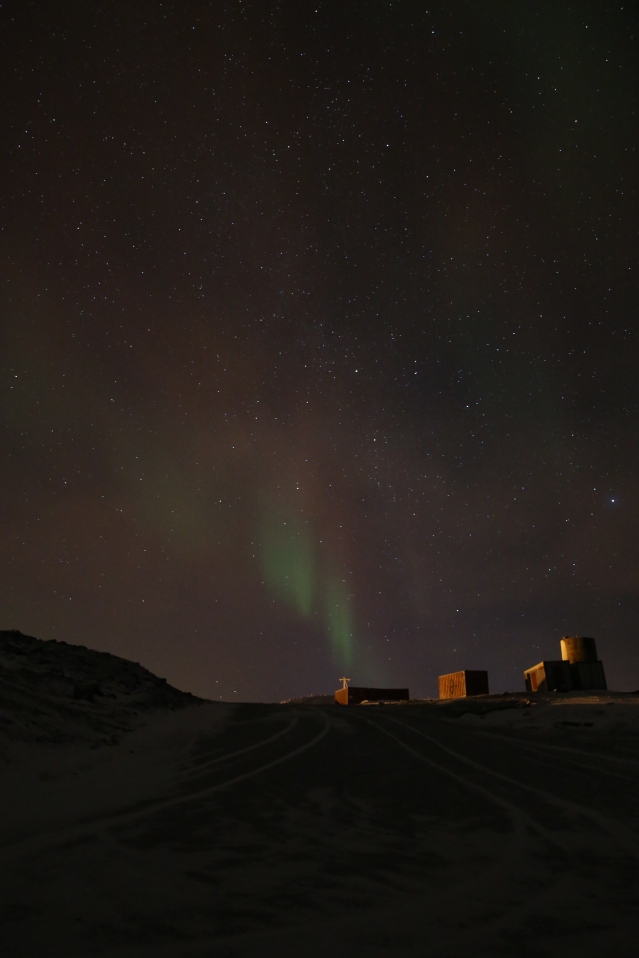 The aurora lights the sky above the hamlet of Ulukhaktok.