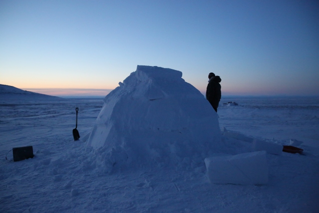Myself standing with the traditional igloo we built with the help of inuit elder, Robert. 