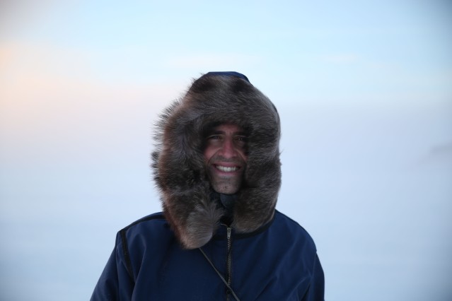 Dr Tristan Pearce poses for a photo outside of Ulukhaktok. 